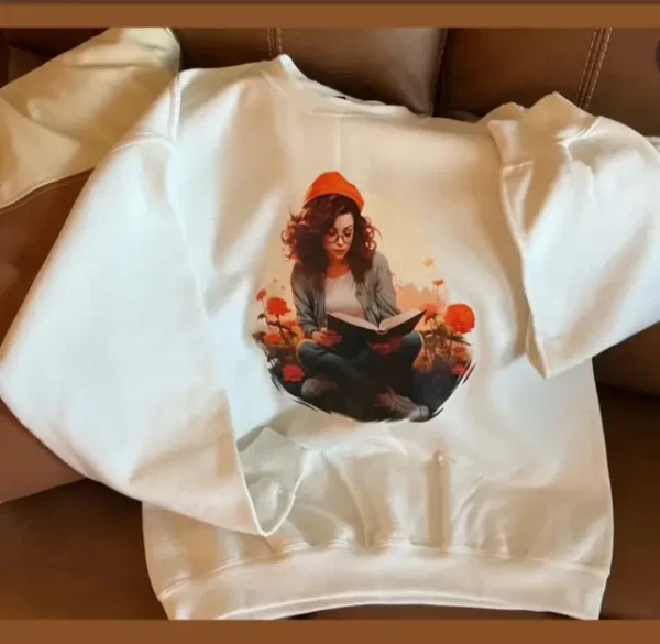 Sweatshirt with woman reading book design.