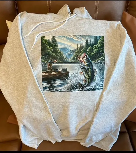 A sweatshirt with a picture of a fish jumping in the water.