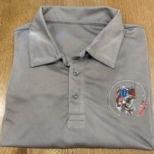 A gray polo shirt with a picture of a person on it.
