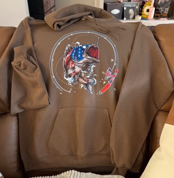 A brown hoodie with an image of a person on it.