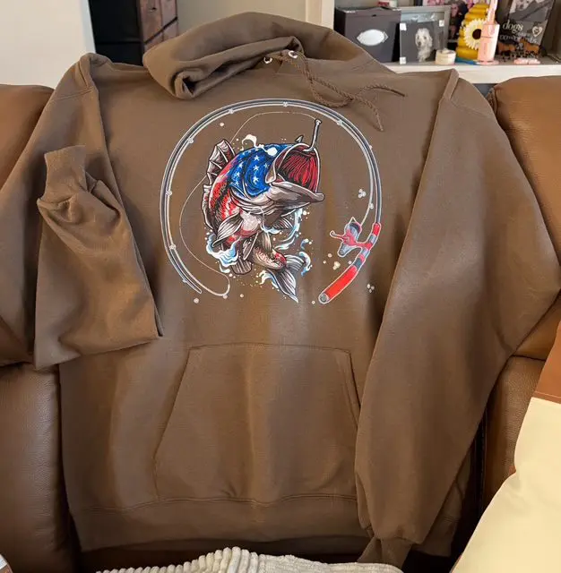 A brown hoodie with an image of a person on it.