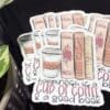 A bunch of stickers that are on top of some books.