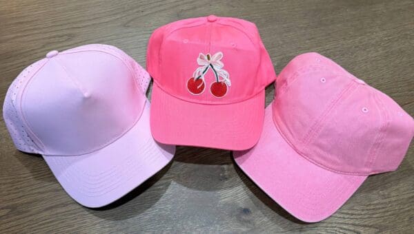 Three hats are sitting on a table.