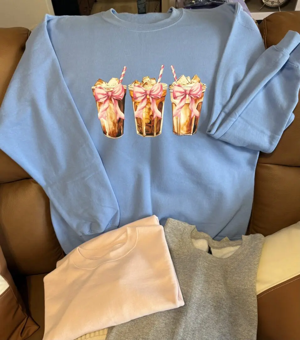Blue sweatshirt with milkshake design and sweaters.