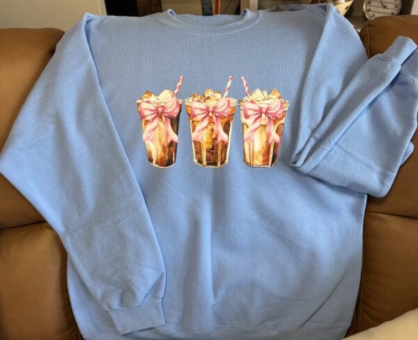 Blue sweatshirt with three milkshake illustrations.