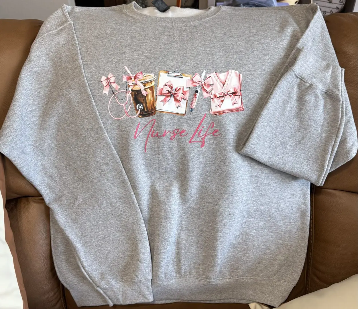 Gray sweatshirt with "Nurse Life" design.