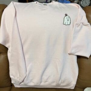 A white sweatshirt with an image of a bottle on it.