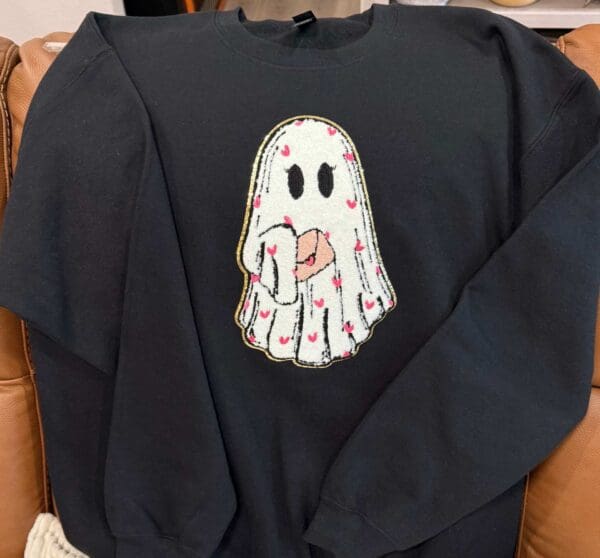 A black sweatshirt with a ghost on it