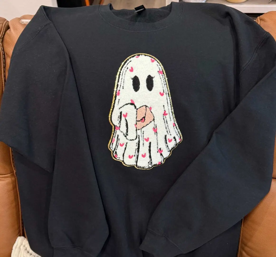 A black sweatshirt with a ghost on it