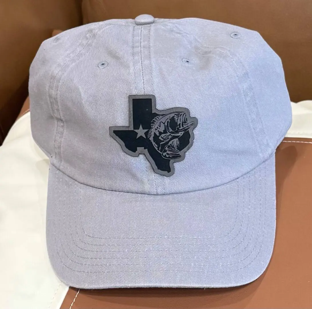 A white hat with a texas state patch on it.