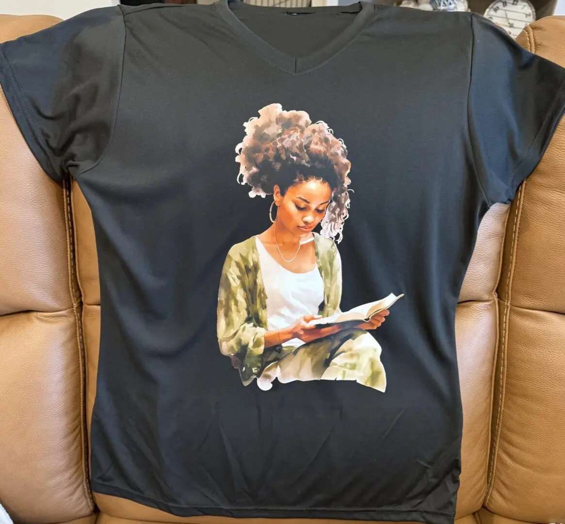 T-shirt with woman reading book design.