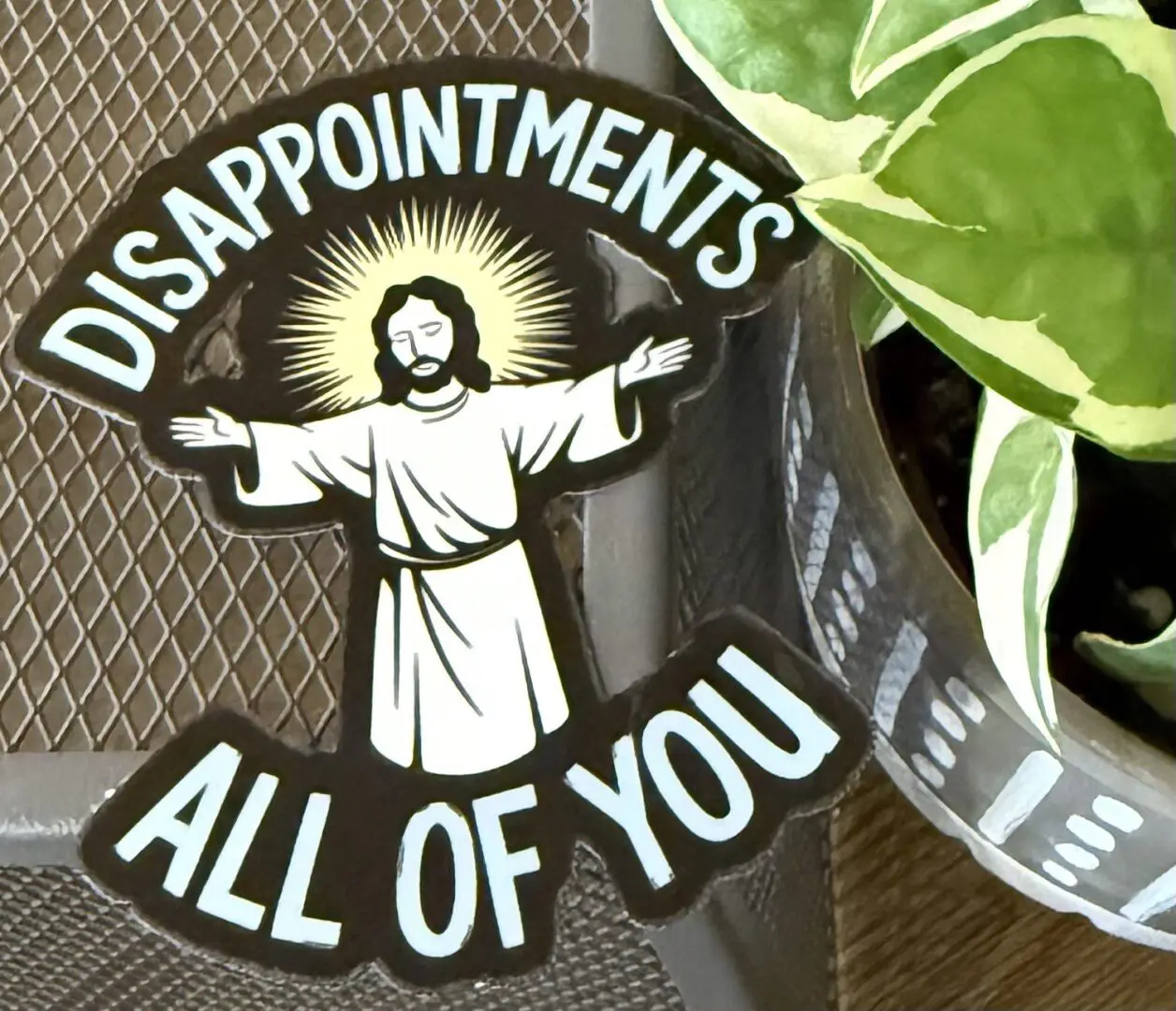 A sticker of jesus with the word disappointments all of you