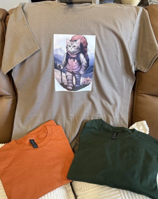 A t-shirt with an image of a cat on it.