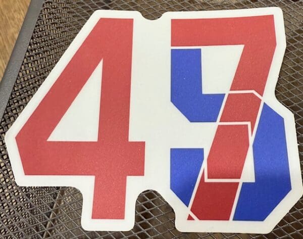 A red, white and blue number 4 7 sitting on top of a table.