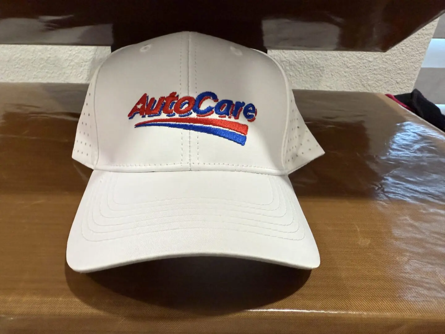 AUTOCARE CAPS White cap with "AutoCare" logo embroidered.