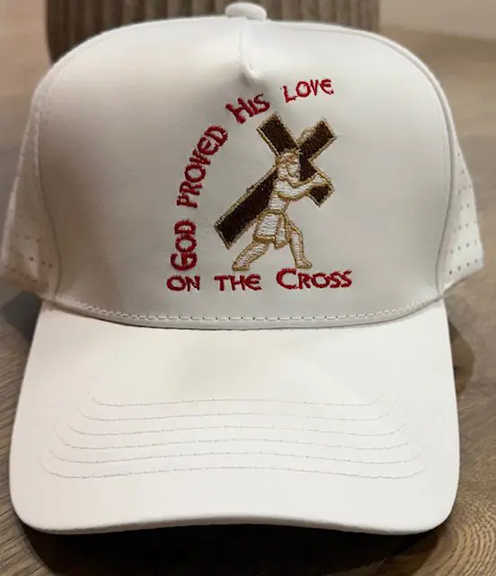 White cap with religious embroidery design.