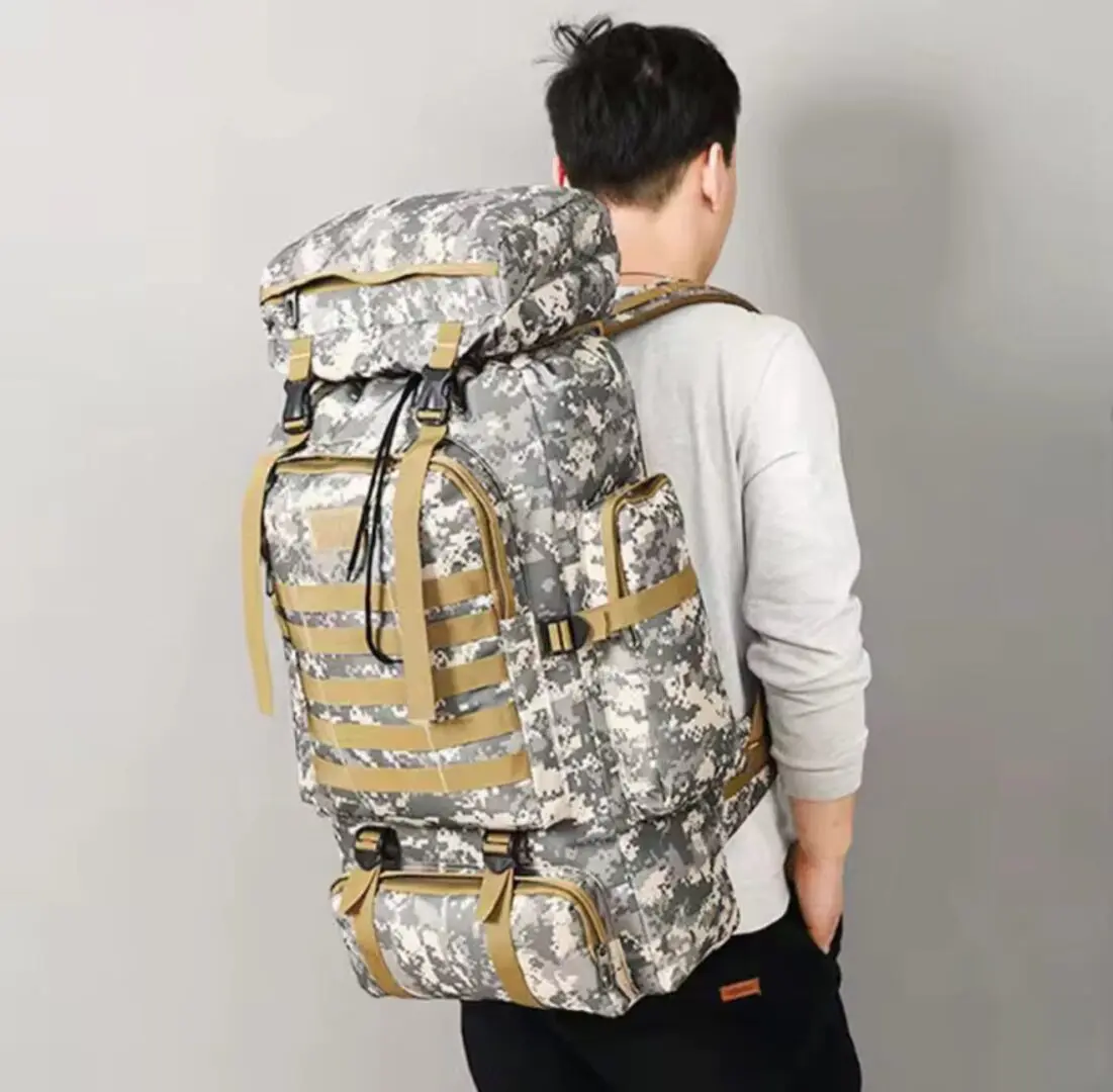 Person wearing large camouflage hiking backpack.