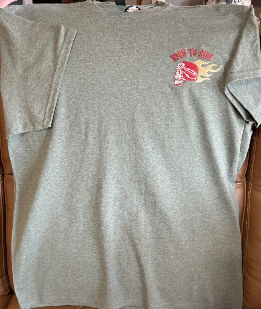 Gray t-shirt with motorcycle skull graphic.