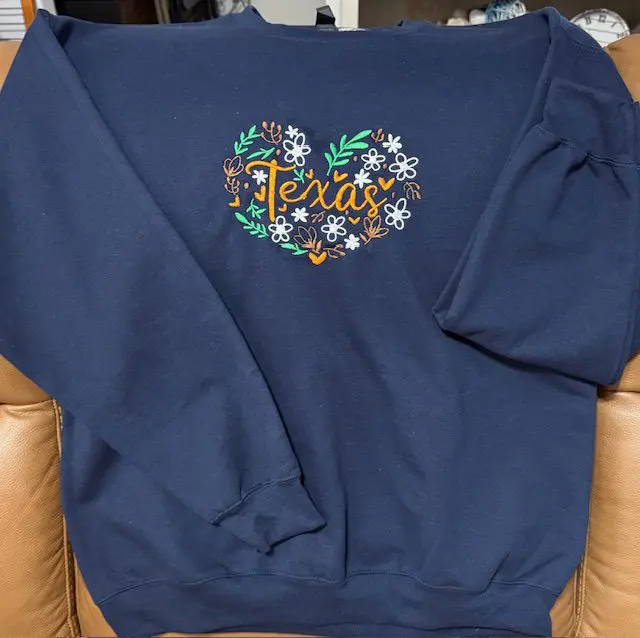 Navy sweatshirt with Texas floral heart design.