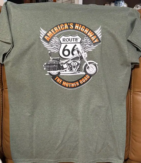 Green T-shirt featuring Route 66 motorcycle graphic.