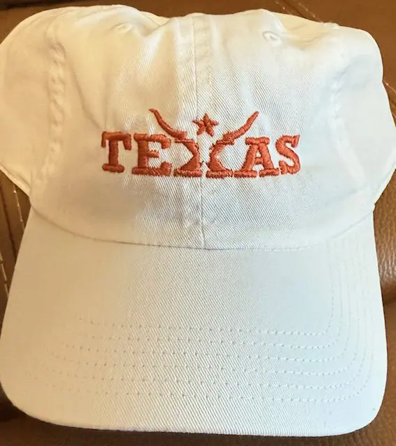 White cap with "Texas" embroidered in orange.