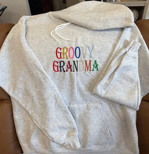 Gray hoodie with "Groovy Grandma" embroidered text.