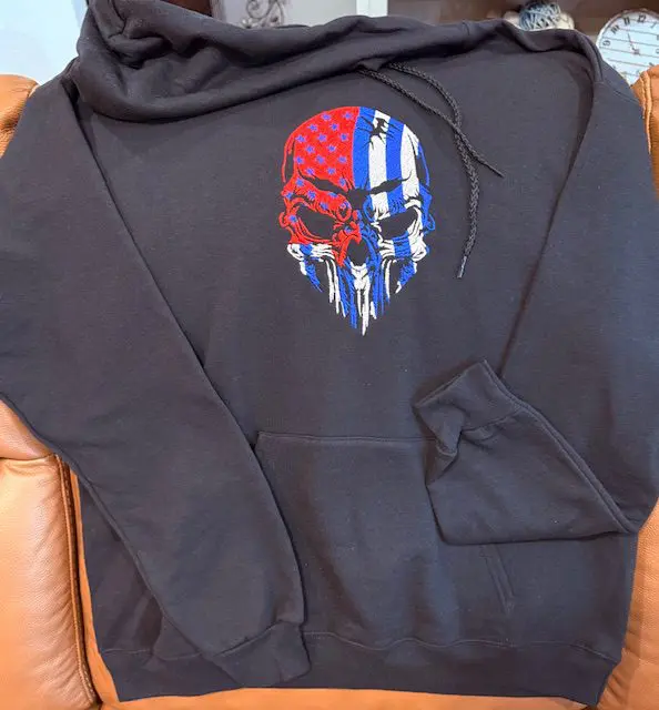 Black hoodie with skull and flag design.