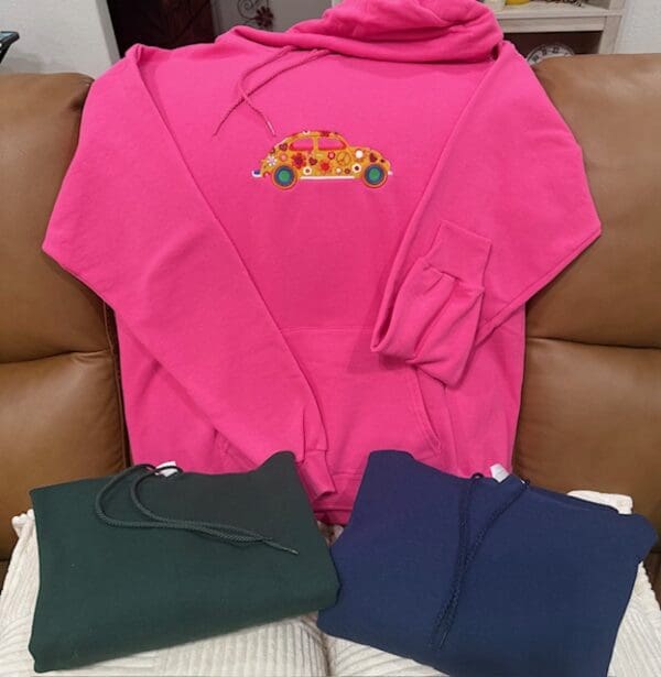 Pink hoodie with car design and others.