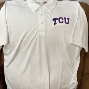 White polo shirt with TCU logo.