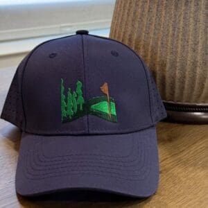 Golf-themed cap on wooden table.