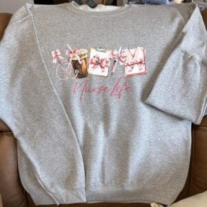 Gray sweatshirt with "Nurse Life" design.