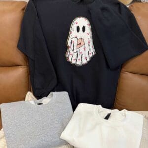 Three sweatshirts, one with ghost design.