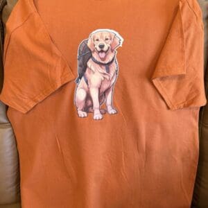 Orange T-shirt with cartoon dog design.