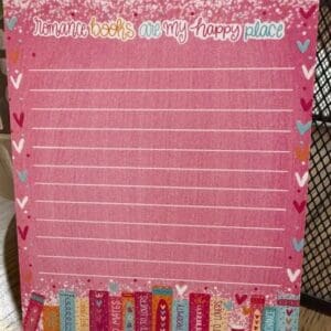 Pink notepad with romance book theme.