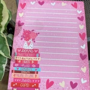 Pink Valentine's Day themed stationery with hearts.