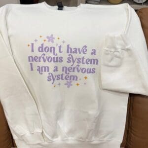 White sweatshirt with humorous purple text.