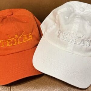 Orange and white Texas embroidered baseball caps.
