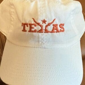 White cap with orange "Texas" embroidery.