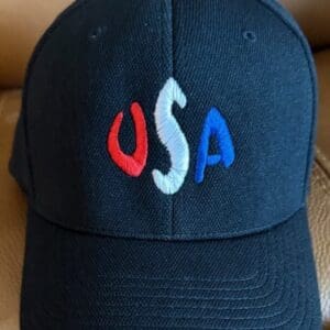 Black cap with USA embroidered in colors.