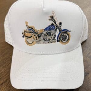 White cap with embroidered motorcycle design.