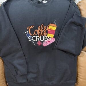 Black sweatshirt with "Coffee & Scrubs" design.