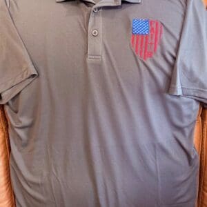 Gray polo shirt with USA flag design.