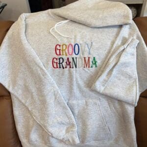 Gray hoodie with "Groovy Grandma" text.