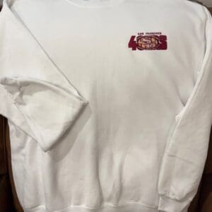 White sweatshirt with San Francisco 49ers logo.