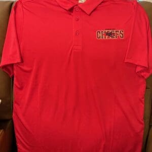 Red polo shirt with Chiefs logo.