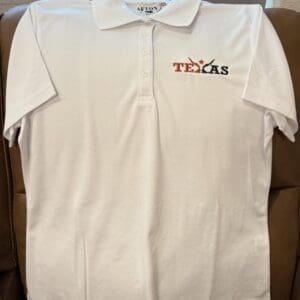 White polo shirt with Texas embroidery design.