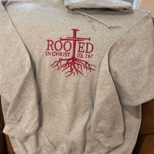 Gray hoodie with "Rooted in Christ" design.