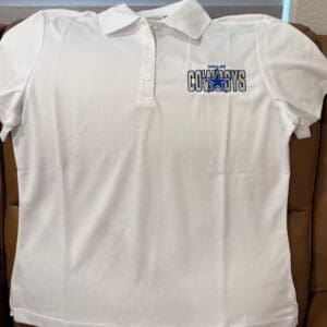 White polo shirt with Cowboys logo.