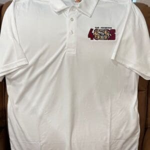 White polo shirt with sports team logo.