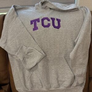 Gray hoodie with purple "TCU" letters.